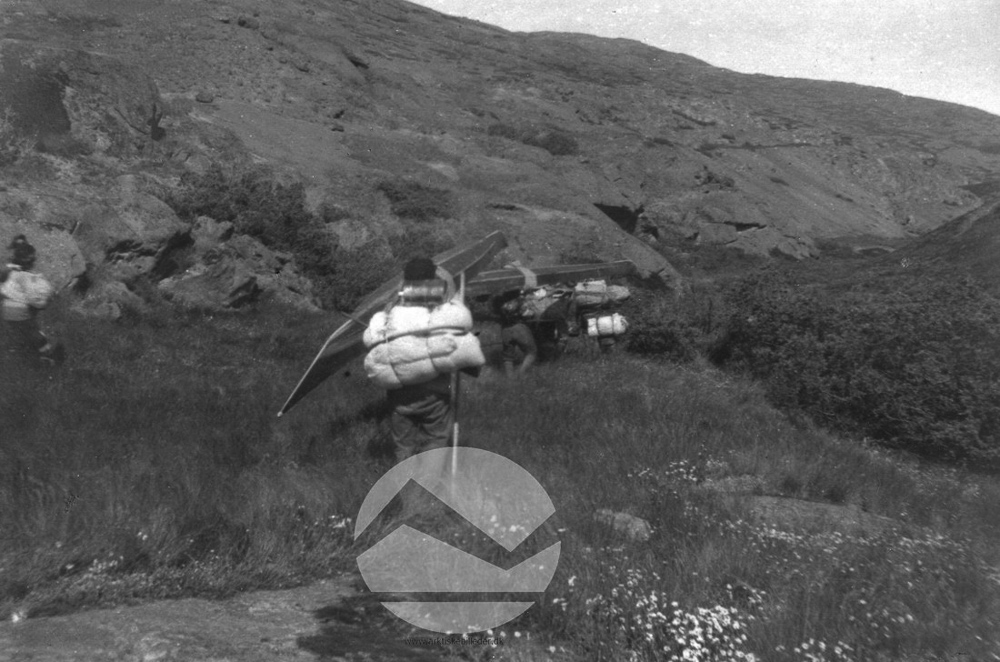 Photograph from between 1925 and 1945 in the collection of the Danish Arctic Institute that shows hunters portaging their kayaks from the fjord to the lake