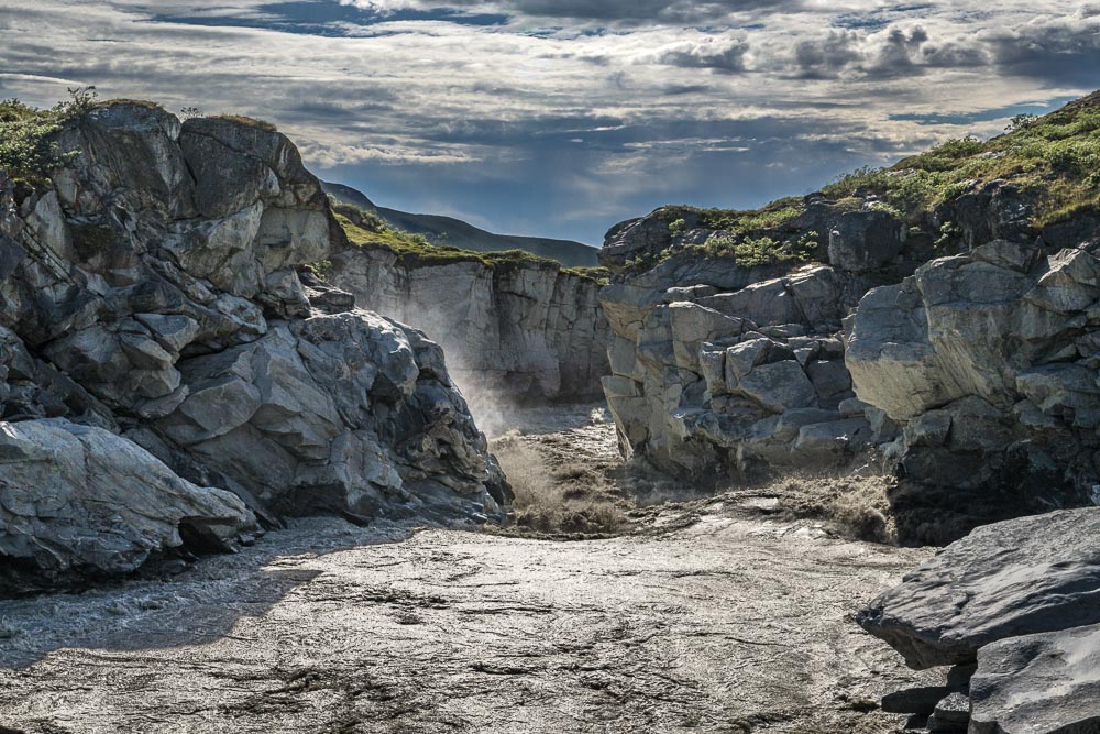River water churning downstream from a waterfall in Greenland 